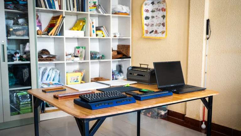 Accessible learning resources including braille devices, assistive technology, and computers at the DYP Learning Center in Cambodia
