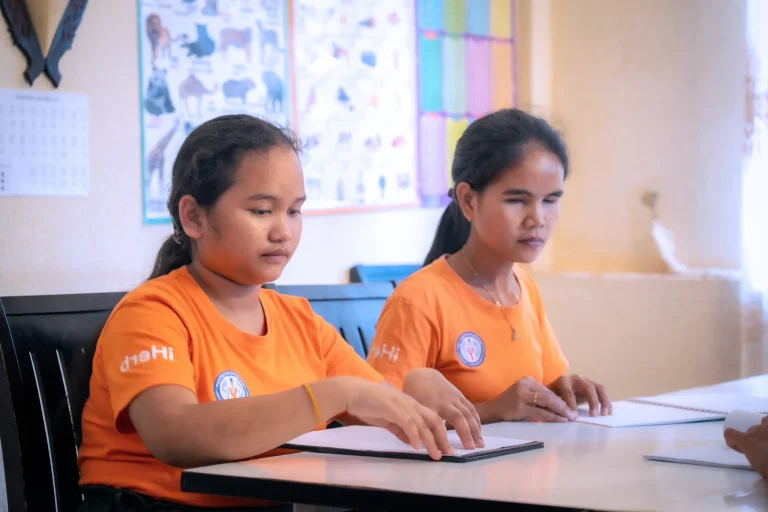 Students learning Braille at the DYP Learning Center in Cambodia through inclusive education support.