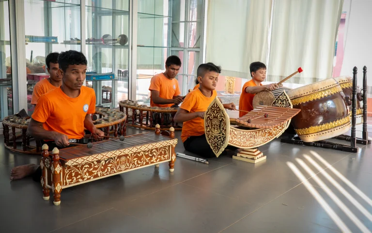 Students with visual impairments learning traditional Cambodian music using classical instruments at the DYP Learning Center in Cambodia