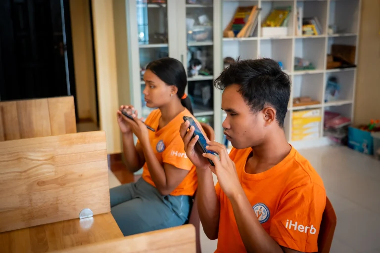 Students using smartphones as assistive technology tools at DYP Learning Center in Cambodia
