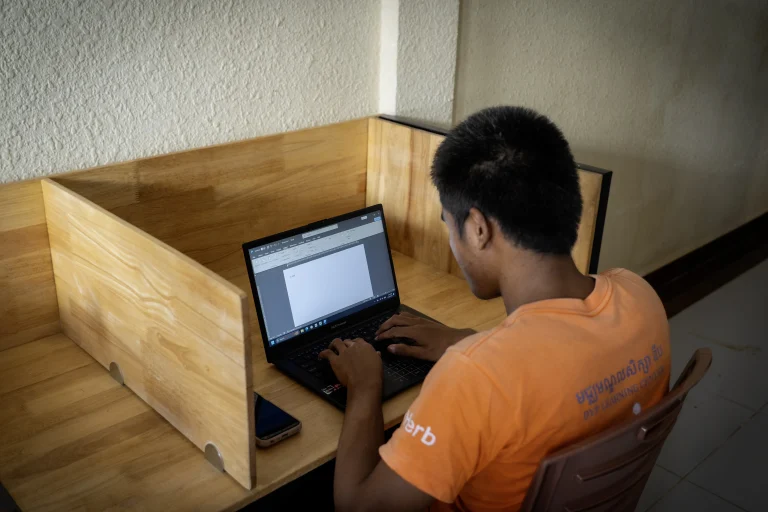Student practicing typing and computer office skills at DYP Learning Center in Cambodia