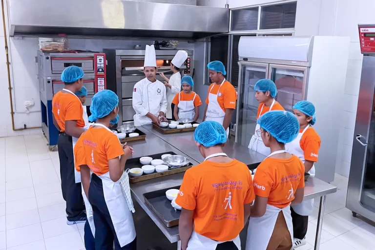 Visually impaired students learning hospitality and baking skills with an EHT chef during a DYP training workshop in Siem Reap, Cambodia.