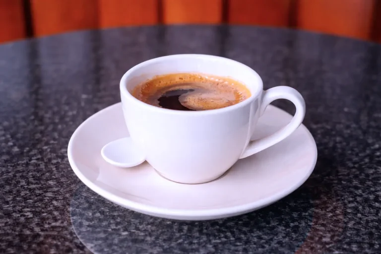 Hot espresso coffee served in a white cup at the DYP Inclusive Café & Bakery in Siem Reap.