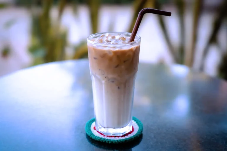 Iced latte coffee with milk and espresso served in a tall glass at the DYP Inclusive Café in Siem Reap.