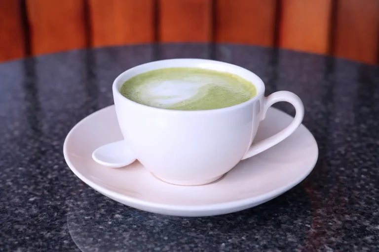 Matcha green tea latte served in a white cup at the DYP Inclusive Café in Siem Reap.
