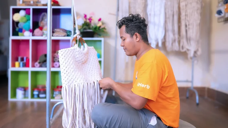 Student with visual impairment learning handicraft weaving at the DYP Learning Center in Cambodia.