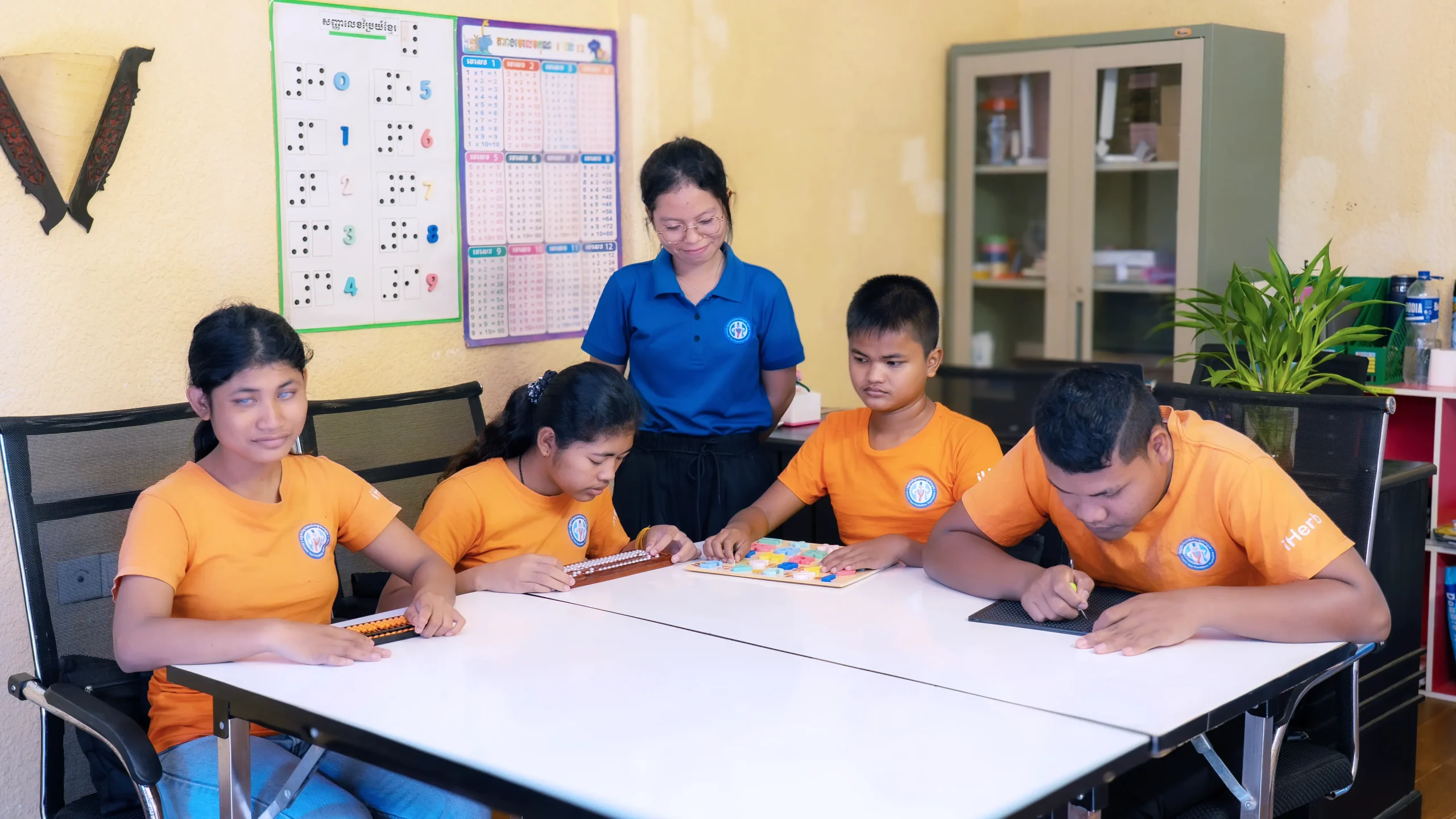 Students with visual impairments learning mathematics using tactile tools at the DYP Learning Center in Cambodia.