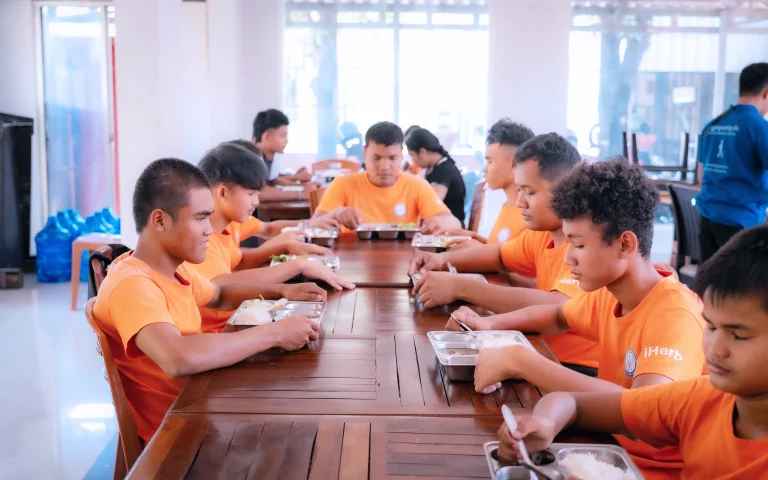Students with visual impairments having a meal together at the DYP Learning Center in Cambodia.