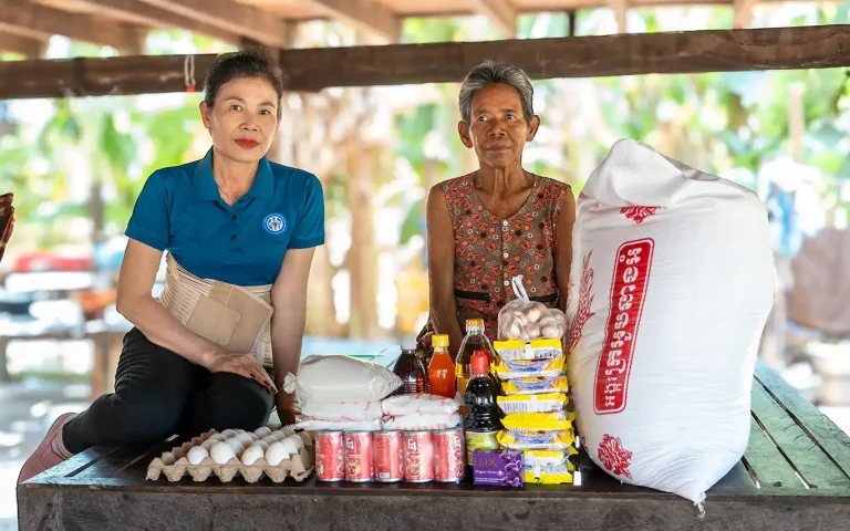 DYP staff delivering food support to a visually impaired woman in Siem Reap Cambodia